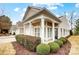 Charming home featuring well-manicured landscaping and a welcoming covered front porch with classic architectural details at 2036 Hudson Ln, Fort Mill, SC 29707