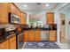 Well-lit kitchen featuring stainless steel appliances, wooden cabinetry, and stylish backsplash at 2036 Hudson Ln, Fort Mill, SC 29707