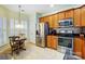 Open kitchen featuring stainless steel appliances, wooden cabinets, and a breakfast nook at 2036 Hudson Ln, Fort Mill, SC 29707