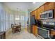 Bright kitchen area features stainless appliances, oak cabinetry, and adjacent dining space at 2036 Hudson Ln, Fort Mill, SC 29707
