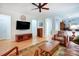 Open-concept living room with hardwood floors, traditional furnishings, and entertainment center at 2036 Hudson Ln, Fort Mill, SC 29707