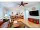 Spacious open-concept living room with hardwood floors, traditional furnishings, and modern entertainment center at 2036 Hudson Ln, Fort Mill, SC 29707