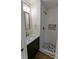 Modern bathroom featuring new vanity with marble countertop and walk-in shower with mosaic tile accents at 21248 Ravenwood Rd, Albemarle, NC 28001