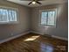 Cozy bedroom featuring hardwood floors and a ceiling fan for comfort at 21248 Ravenwood Rd, Albemarle, NC 28001