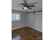 Bedroom featuring hardwood floors, a ceiling fan, and a sliding barn door at 21248 Ravenwood Rd, Albemarle, NC 28001