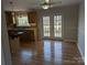 Bright dining area with wooden floors, stainless steel appliances, and access to an outdoor deck at 21248 Ravenwood Rd, Albemarle, NC 28001