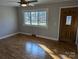 Cozy living room with hardwood floors, a wooden front door, and large windows at 21248 Ravenwood Rd, Albemarle, NC 28001