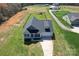 Aerial view showcasing a charming home, surrounded by a lush green lawn and mature trees at 2504 Hovis Rd, Lincolnton, NC 28092