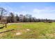 The expansive backyard features an open area with a chicken coop in the distance, perfect for outdoor hobbies at 2504 Hovis Rd, Lincolnton, NC 28092