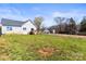 The backyard offers ample space, a wooden deck, and a fenced area, perfect for outdoor activities and relaxation at 2504 Hovis Rd, Lincolnton, NC 28092
