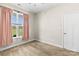 Bedroom with neutral walls, carpet, and window with pink curtains at 2504 Hovis Rd, Lincolnton, NC 28092