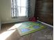 Comfortable bedroom with natural light, and play rug at 2504 Hovis Rd, Lincolnton, NC 28092