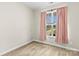 Bedroom with neutral walls, carpet, and window with pink curtains at 2504 Hovis Rd, Lincolnton, NC 28092