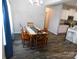 View of a naturally lit dining room with stylish wood flooring and a charming wooden table with seating for four at 2504 Hovis Rd, Lincolnton, NC 28092
