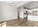 Open dining area showcasing a modern chandelier and views of the adjacent kitchen with wood floors throughout at 2504 Hovis Rd, Lincolnton, NC 28092