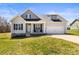 Charming two-story home with a well-maintained lawn, a covered porch, and an attached two-car garage at 2504 Hovis Rd, Lincolnton, NC 28092