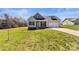 Charming gray single-Gathering home with a well-manicured lawn and inviting curb appeal on a sunny day at 2504 Hovis Rd, Lincolnton, NC 28092