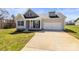 Charming front exterior featuring a well-manicured lawn, cozy porch, and attached two-car garage at 2504 Hovis Rd, Lincolnton, NC 28092