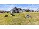 Beautifully landscaped front yard featuring a fire pit area and raised garden beds on a sunny day at 2504 Hovis Rd, Lincolnton, NC 28092