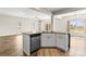 Open-concept kitchen island with granite countertops, stainless steel dishwasher, and modern cabinets in a naturally lit space at 2504 Hovis Rd, Lincolnton, NC 28092