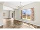 Bright living area with windows and curtains, features wood floors and adjacent dining area at 2504 Hovis Rd, Lincolnton, NC 28092