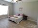 Cozy main bedroom with natural light, simple decor, and plank flooring offering a serene retreat at 2504 Hovis Rd, Lincolnton, NC 28092