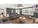 Spacious living room featuring dark gray walls, wood floors, and a large window at 2862 Courtside Dr, Lancaster, SC 29720