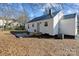 The back exterior features a white vinyl siding, black metal roof, and a small patio with a new AC unit at 312 Motz Ave, Lincolnton, NC 28092