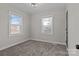 Bedroom featuring two windows, carpeted flooring, and a ceiling light at 312 Motz Ave, Lincolnton, NC 28092