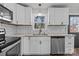 Well-lit kitchen with white cabinets and stainless steel appliances at 312 Motz Ave, Lincolnton, NC 28092
