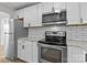 Modern kitchen features stainless steel appliances, white cabinetry and subway tile backsplash at 312 Motz Ave, Lincolnton, NC 28092