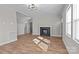 Spacious living room featuring vinyl floors, a decorative fireplace, and fresh paint, creating a cozy atmosphere at 312 Motz Ave, Lincolnton, NC 28092