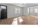 Bright living room with freshly painted walls and new vinyl flooring, showcasing natural light and a modern touch at 312 Motz Ave, Lincolnton, NC 28092