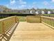 Newly constructed wooden back deck with railings overlooking a fenced backyard at 352 Anvil Draw Pl, Rock Hill, SC 29730