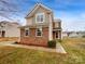 Charming two-story home boasts a stone and siding facade and a well-manicured lawn at 352 Anvil Draw Pl, Rock Hill, SC 29730