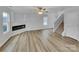 Spacious living room featuring sleek floors, a modern fireplace, and ample natural light at 352 Anvil Draw Pl, Rock Hill, SC 29730