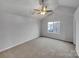 Spacious bedroom featuring a ceiling fan, window, and neutral-colored walls and flooring at 352 Anvil Draw Pl, Rock Hill, SC 29730