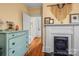 Bedroom featuring hardwood floors, decorative fireplace, and a soft blue dresser at 357 W Mclelland Ave, Mooresville, NC 28115