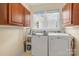 A bright laundry room featuring a new washer and dryer and built in storage at 357 W Mclelland Ave, Mooresville, NC 28115