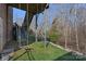 Backyard view featuring the wooden deck support structure, hanging swings, and sloping green lawn at 3608 Mcpherson St, Waxhaw, NC 28173