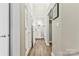 Hallway featuring multiple storage closets and a view into the bathroom at 404 New Bern Station Ct, Charlotte, NC 28209