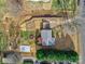 Aerial view of a home with a fire pit, garden, shed, long driveway and mature landscaping at 432 Lake Shore Dr, Fort Mill, SC 29715