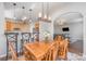 View of dining area with wooden table and bar seating, connecting to a modern kitchen and cozy living room at 4586 Little Leaf Ln, Rock Hill, SC 29732