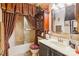 Cozy bathroom features a vanity, cabinet, and bathtub with an ornate paisley shower curtain at 4811 Spring Lake Dr # C, Charlotte, NC 28212