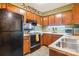 Functional kitchen with wooden cabinets, essential appliances, and ample counter space, ready for culinary adventures at 4811 Spring Lake Dr # C, Charlotte, NC 28212