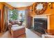 Comfortable sitting area with plush chair and fireplace, bathed in natural light from the large window at 4811 Spring Lake Dr # C, Charlotte, NC 28212