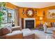 Inviting living room featuring a fireplace, a large window, and comfortable seating in a cozy setting at 4811 Spring Lake Dr # C, Charlotte, NC 28212