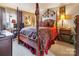 Elegantly furnished main bedroom with a grand four-poster bed and tasteful decor, creating a luxurious retreat at 4811 Spring Lake Dr # C, Charlotte, NC 28212