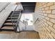 Exterior staircase, with brick walls, that leads to a parking area with a car at 4811 Spring Lake Dr # C, Charlotte, NC 28212
