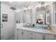 Bright bathroom featuring a double vanity with marble countertops and walk-in shower with white subway tile surround at 5217 Addison Ave, Charlotte, NC 28211